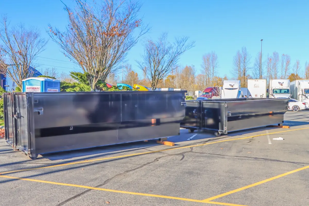 Professional dumpster rental service with roll-off container on residential driveway in Donaldsonville